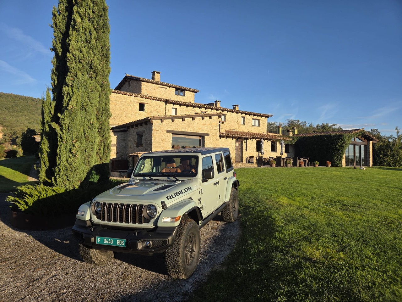 An SS Performance Jeep Wrangler Rubicon in front of a stone farmhouse
